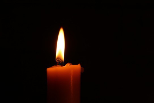 Closeup of a single candle burning.