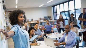 Woman leading a meeting, going through the fundraising event planning checklist