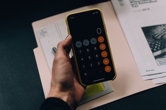 Hand holding a calculator.