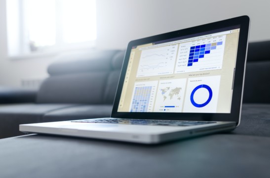 Laptop screen with data trends and charts.