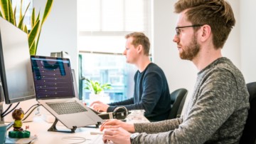 two men at their computers