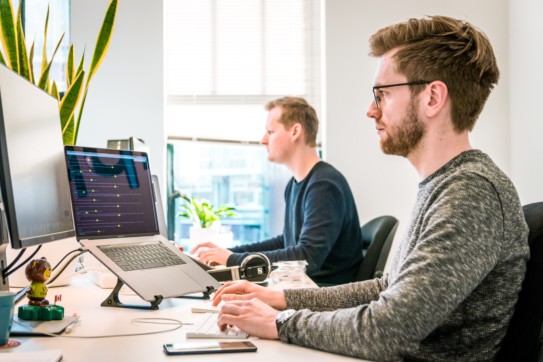 two men at their computers